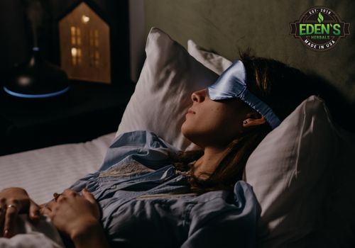 woman sleeping in bed with eye mask on